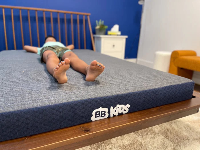 A 10-year-old boy testing out the BB Kids mattress in the back-sleeping position.