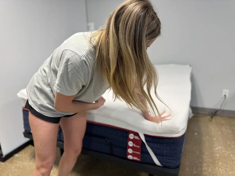 Our tester leans on the corner of a TEMPUR-Pedic TEMPUR-Adapt Topper