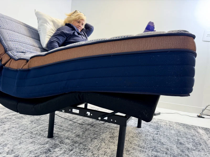 Our tester tries to get settled into a Copperflex on an adjustable bed frame. 
