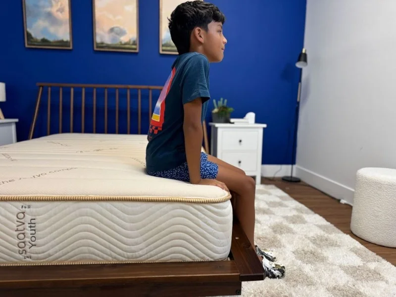 Our tester does a seated edge support test on the Saatva Youth Mattress
