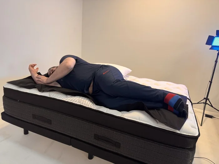 A man lying on his side on the Nolah Evolution mattress.