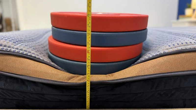 Our tester measures the deflection of weight plates along the edge of the Brooklyn Bedding CopperFlex Mattress