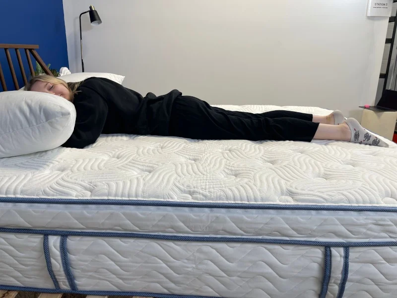 Our tester stomach-sleeping on the DLX Premier Hybrid