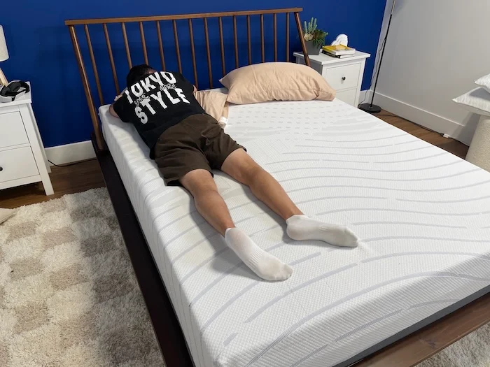 A man stomach sleeping on the BodiPedic 12" mattress.