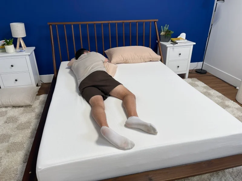 Our tester stomach-sleeping on the PolySleep Sierra Mattress