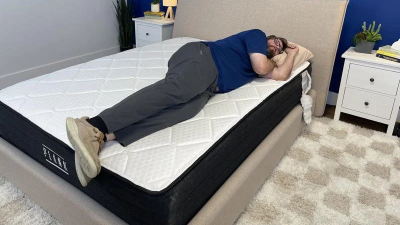 Our tester side sleeping on the Brooklyn Bedding Plank Firm Luxe Mattress