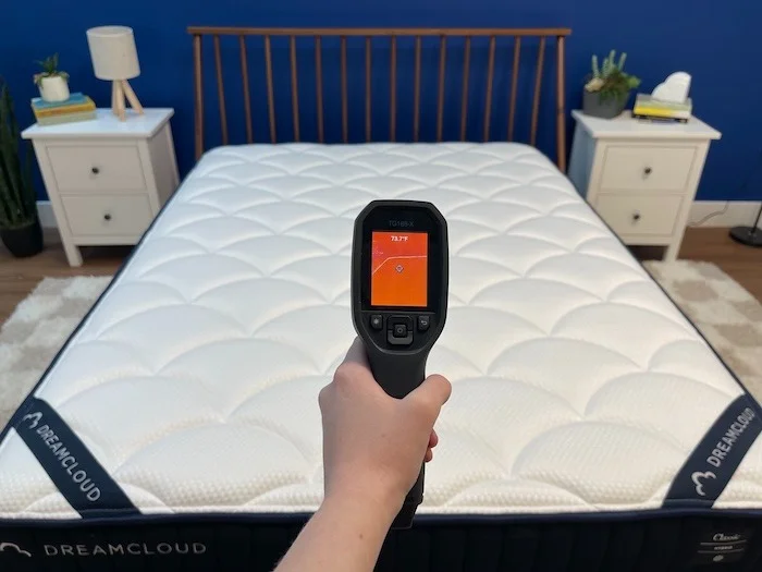 A closeup of a thermal gun reading the DreamCloud mattress's temperature at a neutral state. The screen says 73.7 degrees.