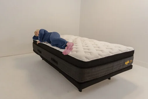 A woman lying on the Nolah Evolution mattress in the side-sleeping position.