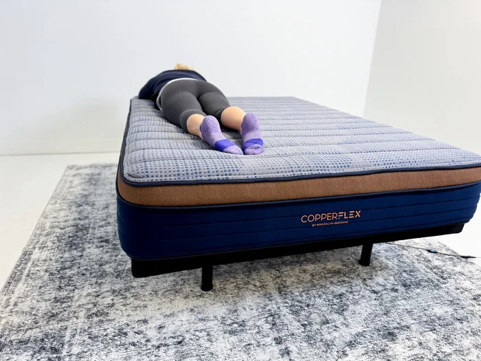 A person stomach sleeping on the Brooklyn Bedding CopperFlex Mattress
