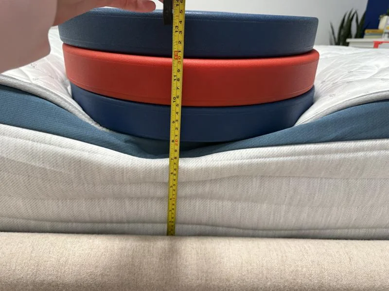 Measuring weight plates on the edge of the Helix Twilight Mattress