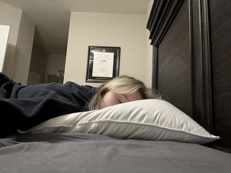 Our tester stomach-sleeping on the Helix Down Pillow