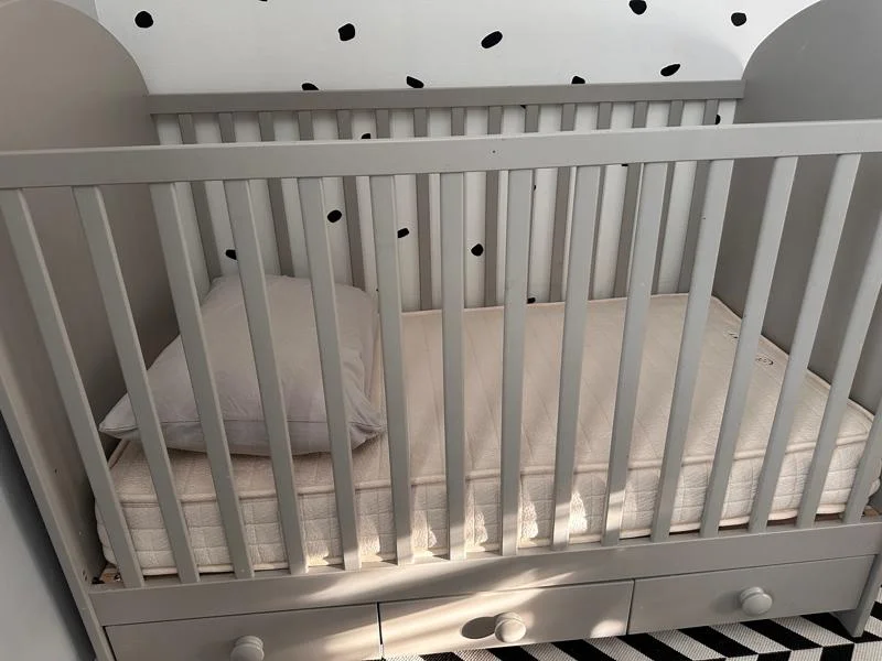 Avocado Luxury Crib Mattress in a nursery
