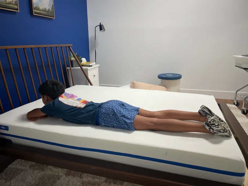 Our young tester stomach-sleeping on a Nectar Kids Mattress