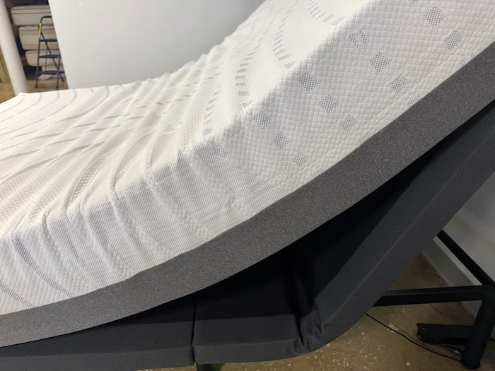 A BodiPedic 12" Mattress sitting upright on an adjustable base.