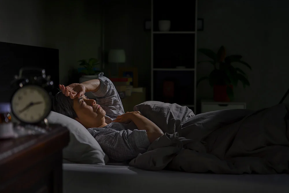 person laying awake in bed