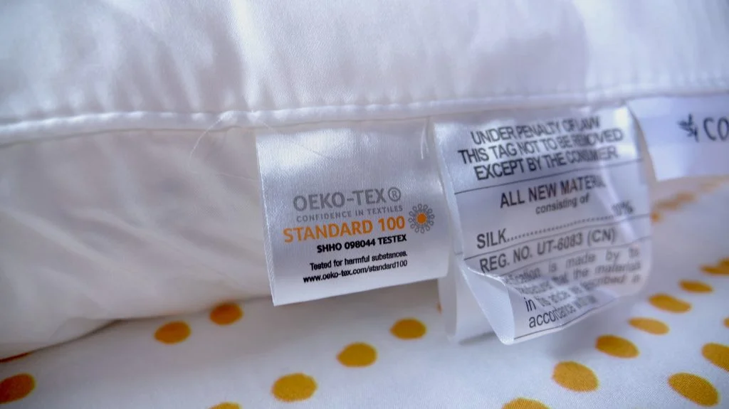 Tags on a Cozy Earth Silk Pillow