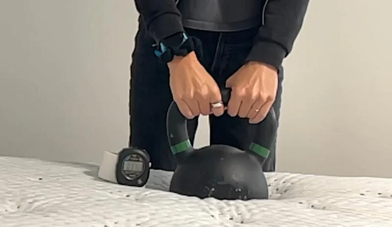 Our product tester conducting a responsiveness test on the Tulo Mattress