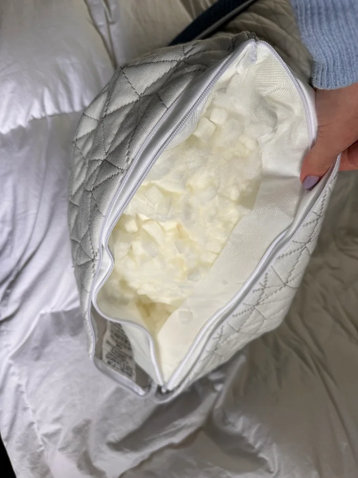An unzippered pillow showing a case full of adjustable filling.