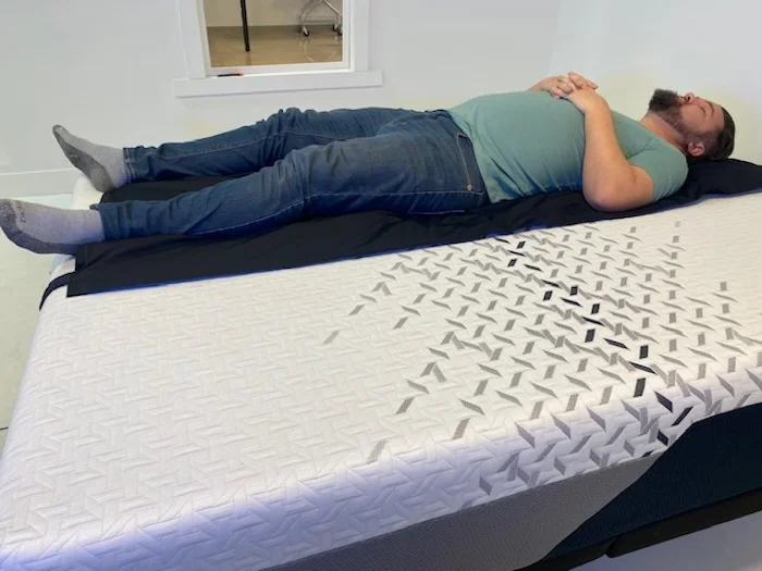 A man lying on his back on the Nectar Luxe Memory Foam mattress.