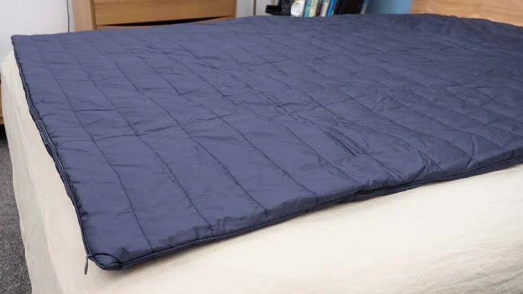 The Sleep Number True Temp weighted blanket on a bed