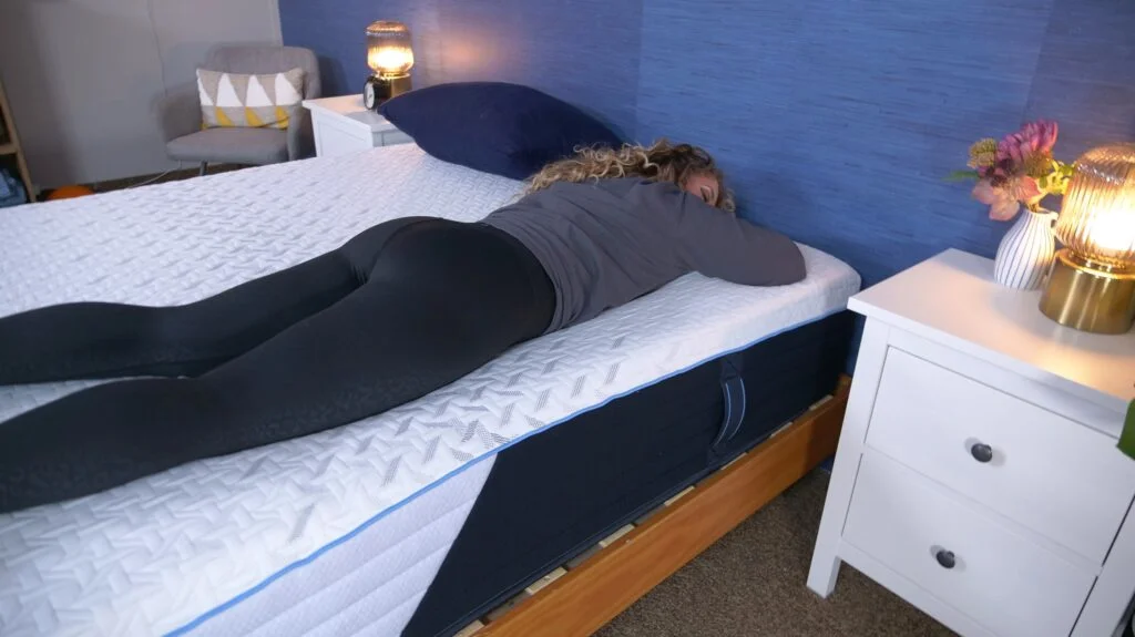 A person is shown stomach-sleeping on a Nectar Classic Hybrid mattress