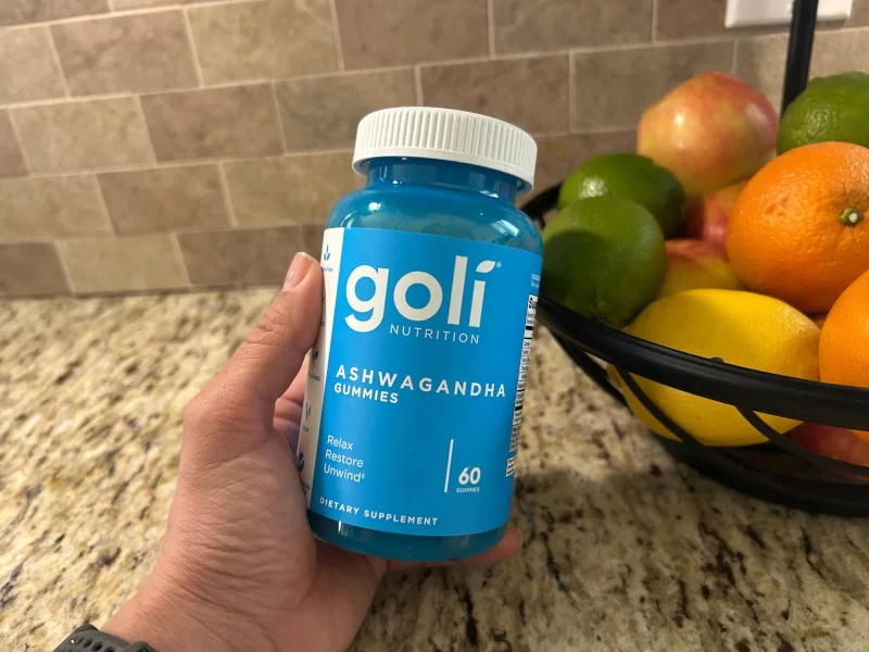 Our tester holding a bottle of Goli Ashwaganda Gummies.