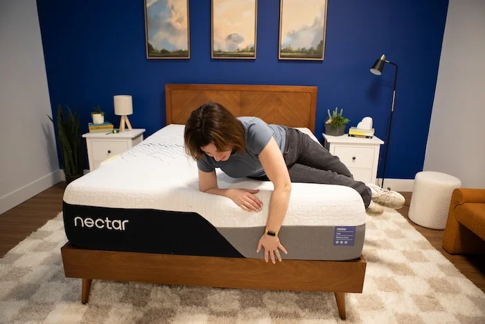 A woman lying on a mattress that's on top of the Bear Summit Platform Bed with Headboard.