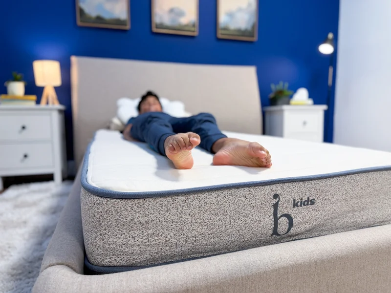 A mattress tester back sleeping on the Birch Kids mattress.