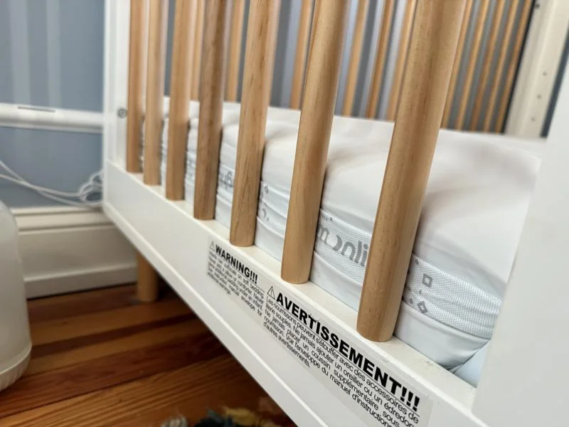 A close look at the logo on the side of a Moonlight Slumber Little Dreamer Crib Mattress