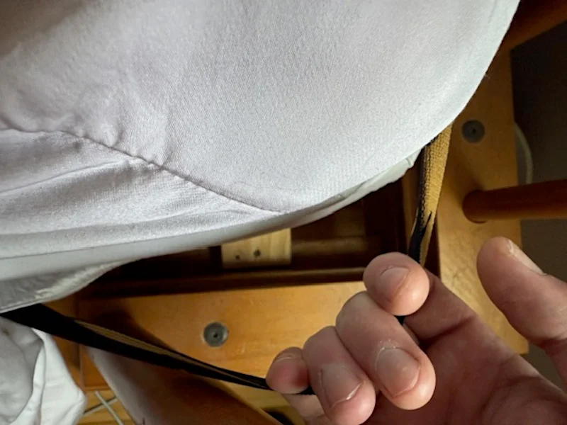 Our tester grabs the corner strap on a LUXOME Luxury Sheet