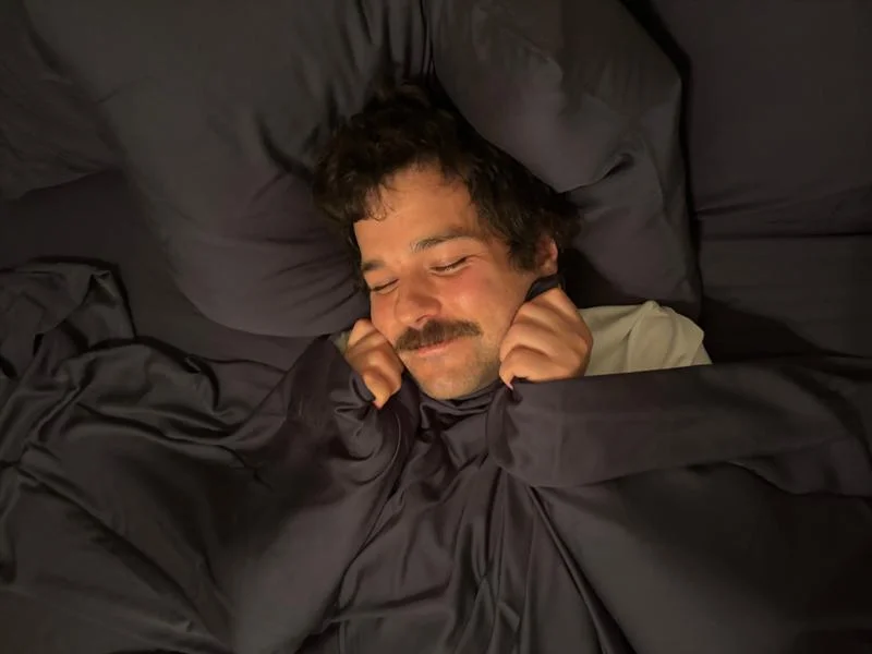 Our tester looking super cozy with a Nest Bedding Bamboo Sheet Set