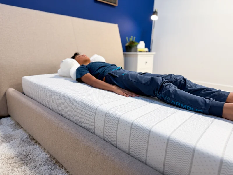 A tester back sleeping on the Leesa Kids mattress.