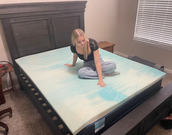Our tester gets a feel for the Brooklyn Bedding Gel Swirl Memory Foam Mattress Topper