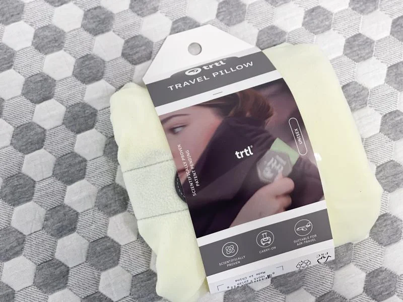 Looking at a trtl Travel Pillow In the Packaging