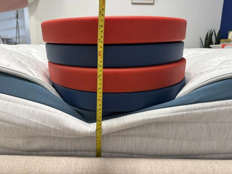 Measuring weight plates on the edge of the Helix Twilight Mattress