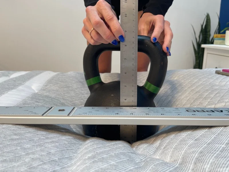 Our tester does a sinkage test on the Leesa Plus Hybrid mattress