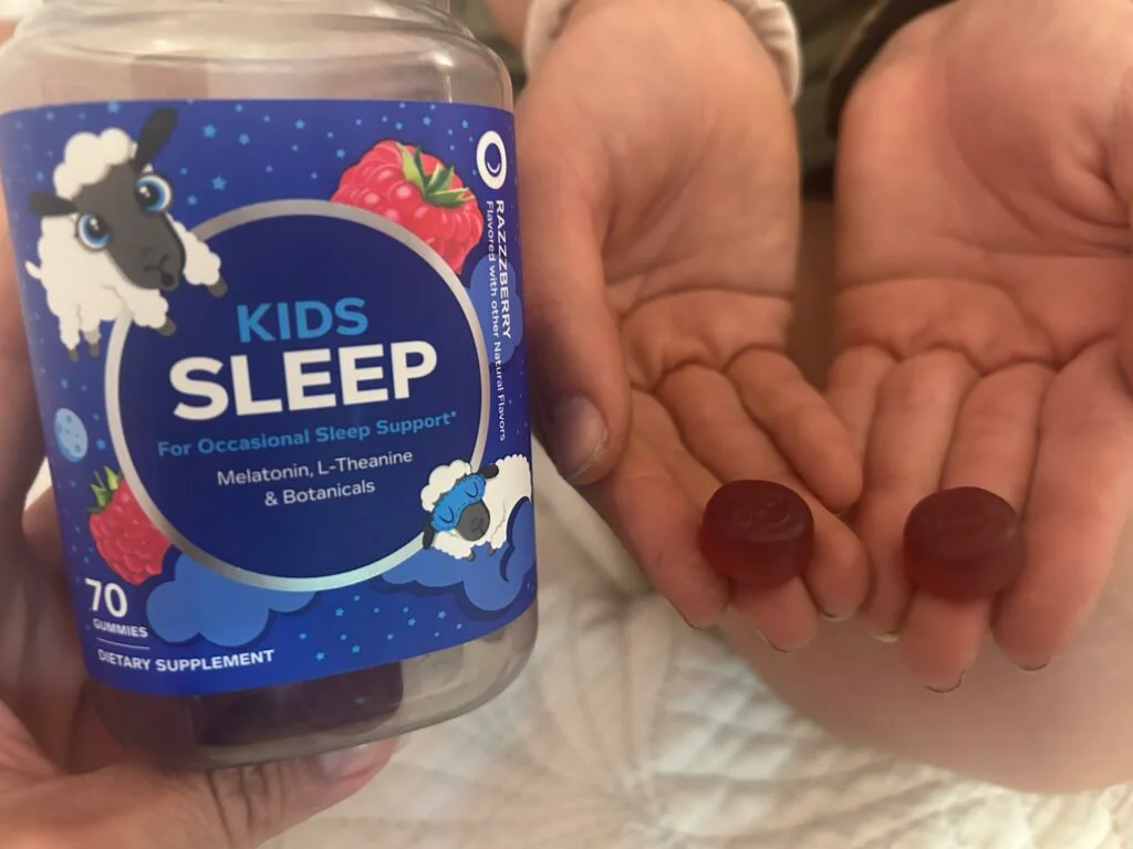 Our tester holds out her hands holding Olly Sleep gummies