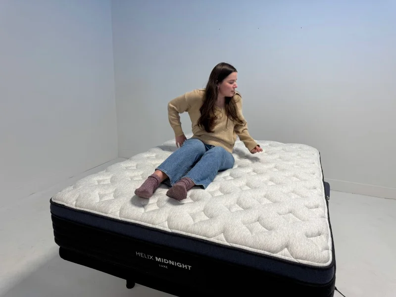 Our tester rolls around on a Helix Midnight Luxe Mattress to assess it's responsiveness