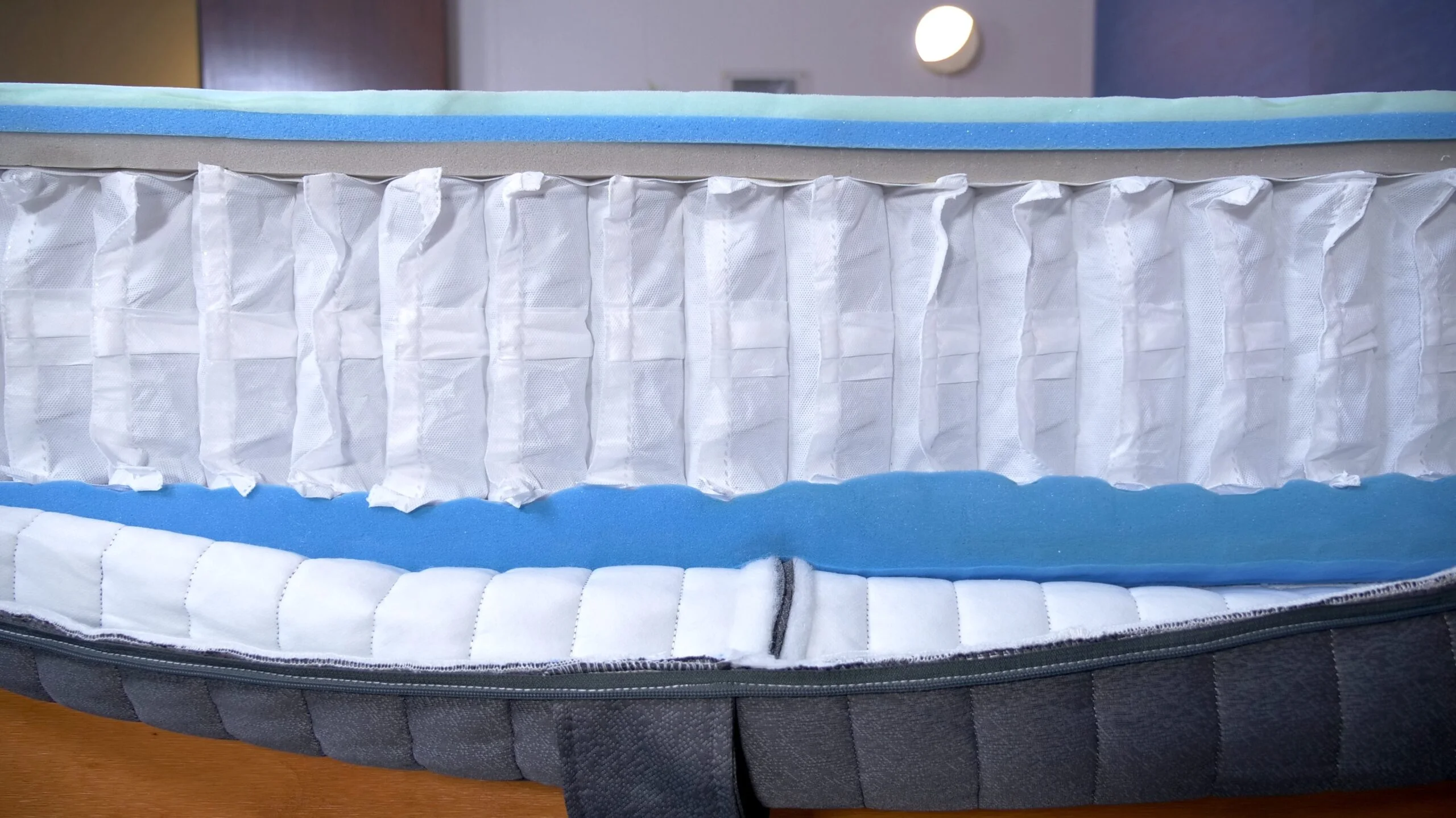 The internal contruction of an Emma Hybrid Comfort Mattress is cut open for examination