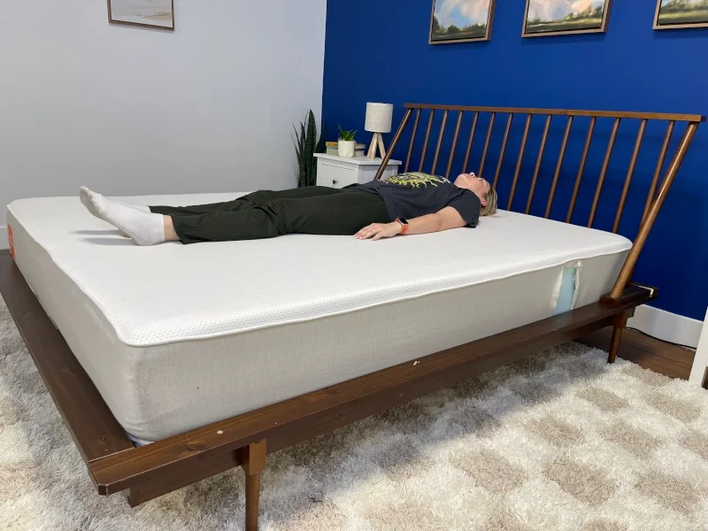 Our tester back-sleeping on a Boring AF Mattress