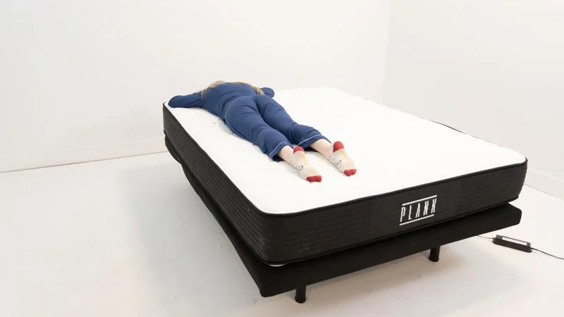 Our tester stomach sleeping on the Plank Firm Mattress