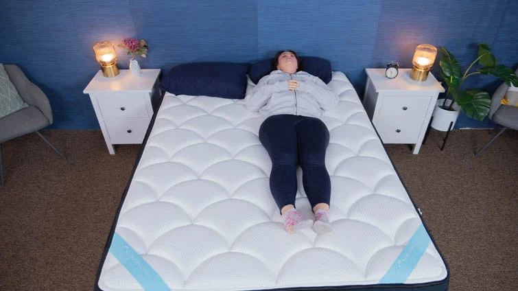 Amelia doing the "Rest Test" on the DreamCloud Premier.