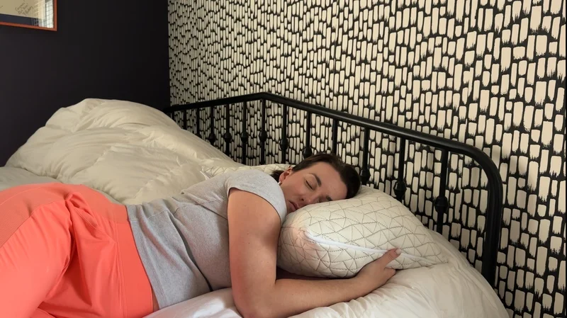 Our tester sleeping on a Coop Sleep Goods Original Adjustable Pillow