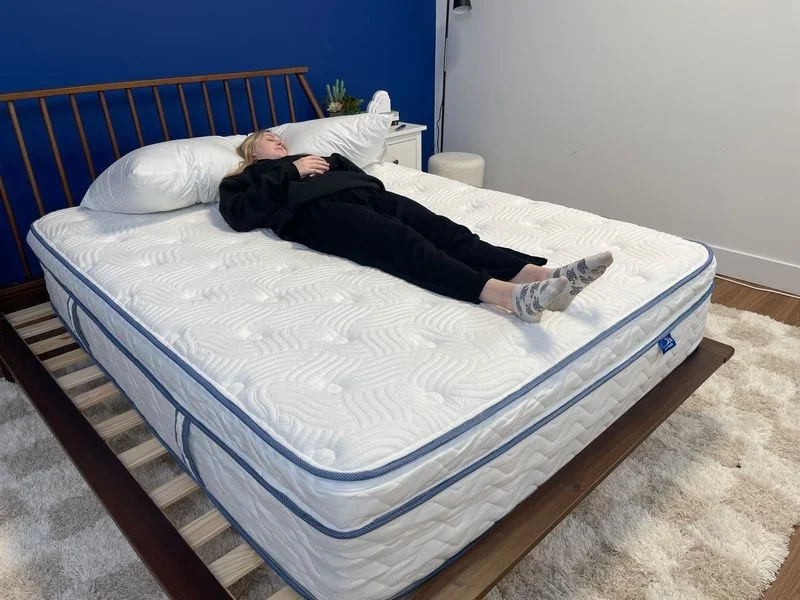 Tester Riley Otis back-sleeping on the DLX Premier Hybrid