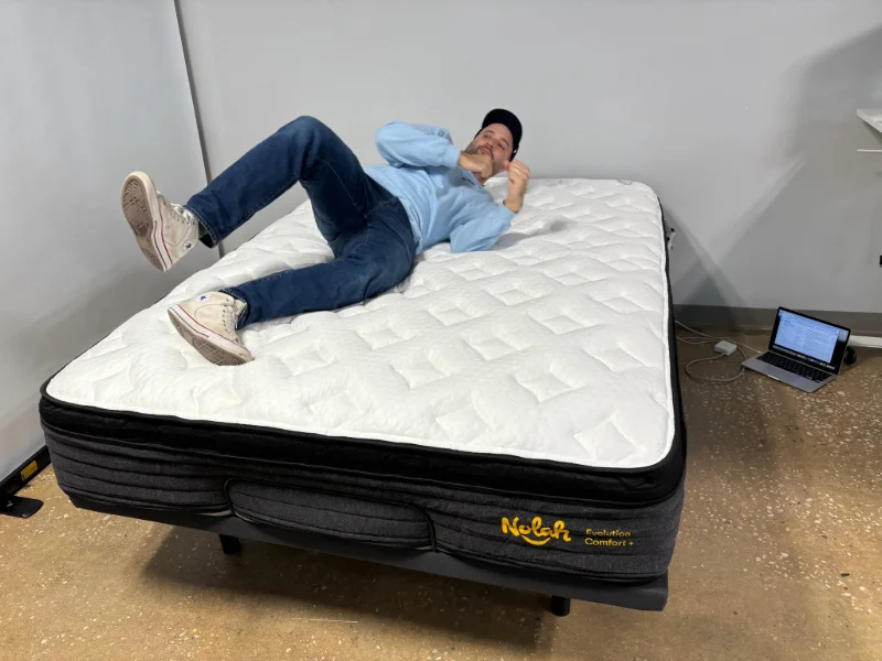 A mattress tester assessing the responsiveness of the Nolah Evolution Comfort Plus.