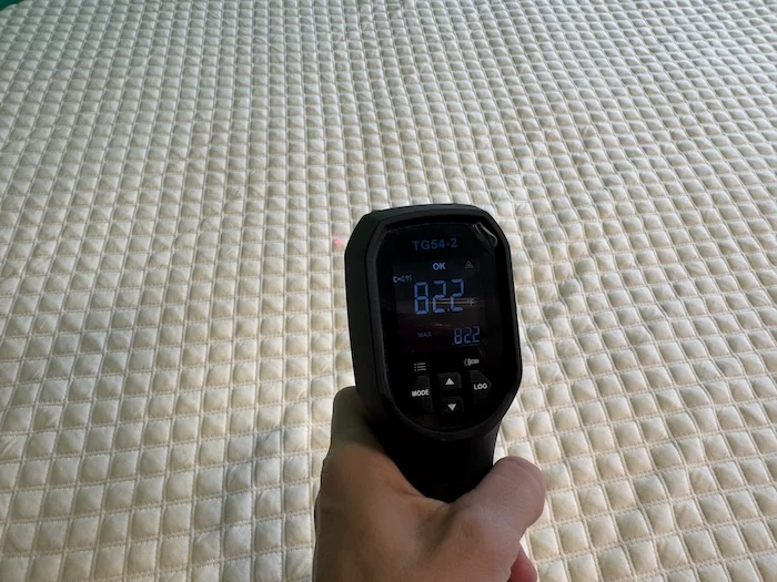 A person takes a thermal reading from the Nolah Mattress Topper
