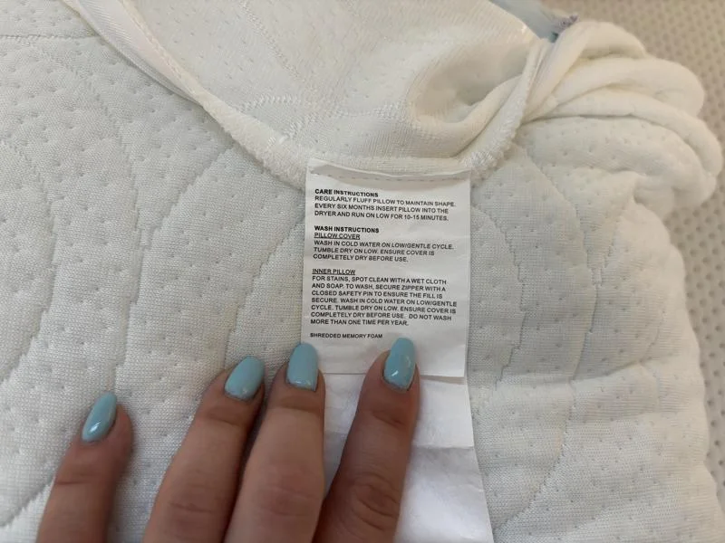 Care tag on The Otter pillow by Lagoon