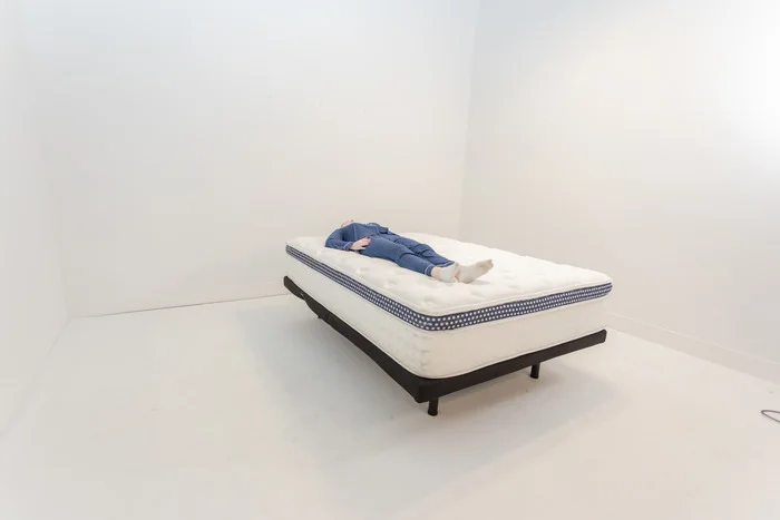 A woman lying on the WinkBed on her back.