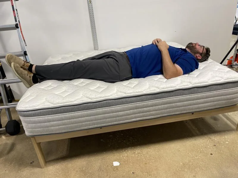 Our tester back-sleeping on the Helix Plus Mattress
