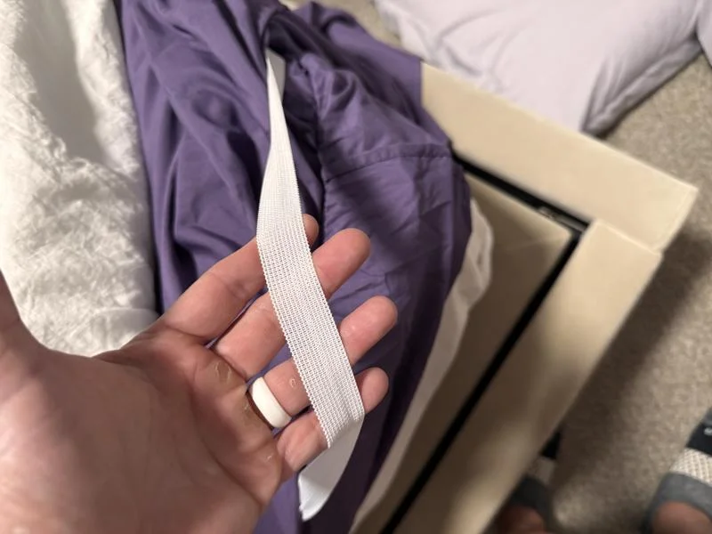 Our tester shows the corner strap on a Cosy House Luxury Bamboo Sheet Set